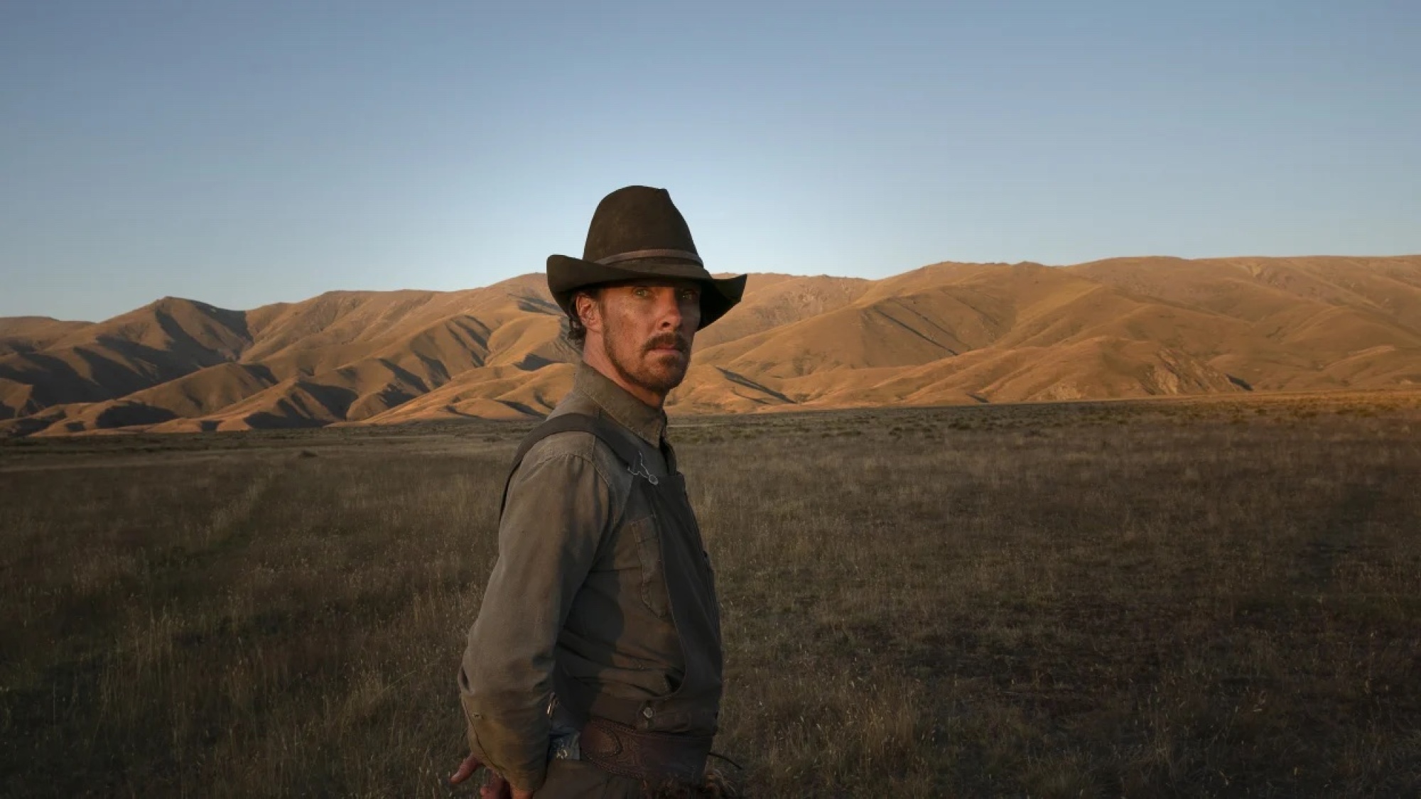 Un homme dans un cow-boy se tient dans les plaines.