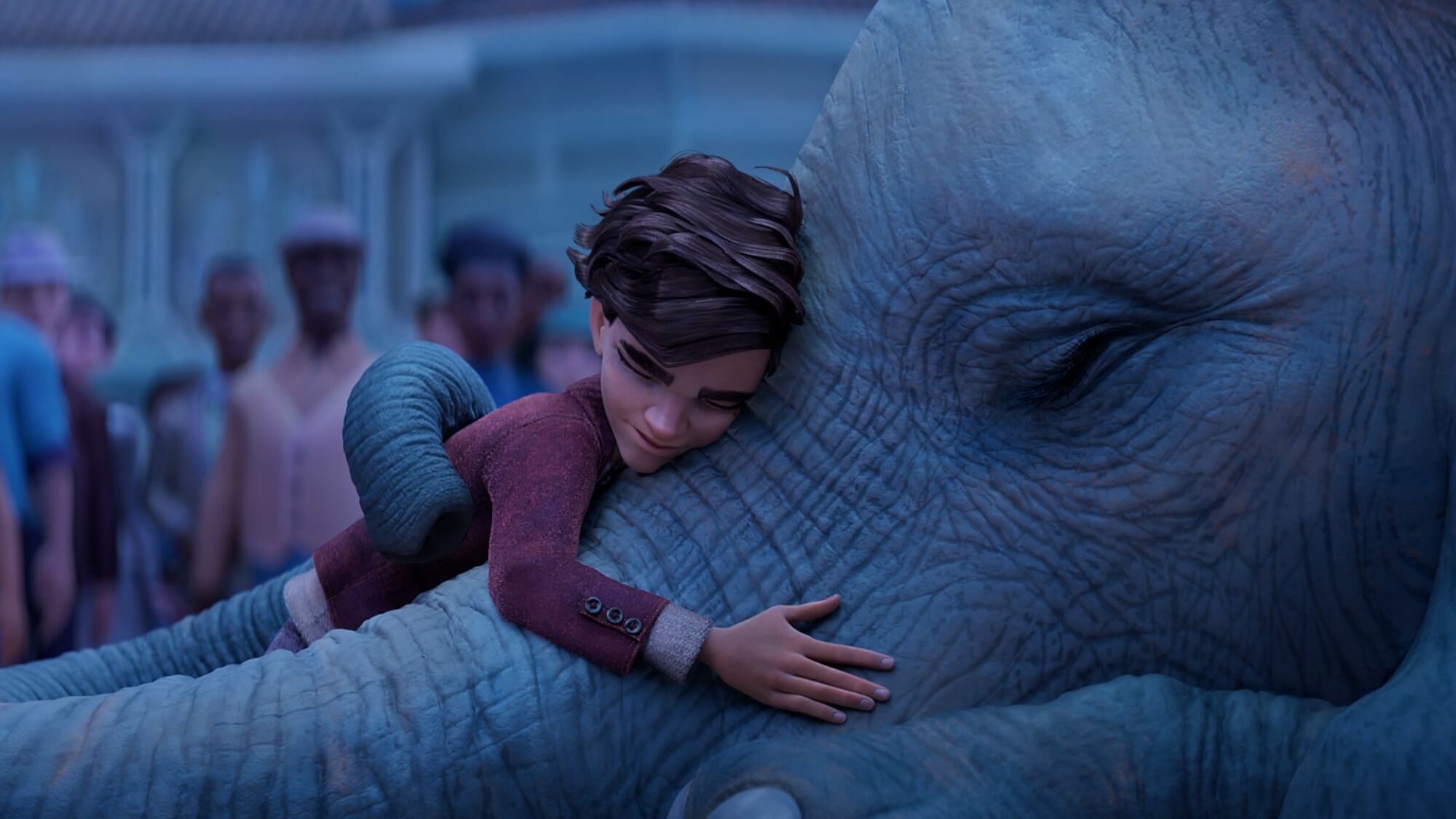 Un garçon embrasse un éléphant dans "L'éléphant du magicien."