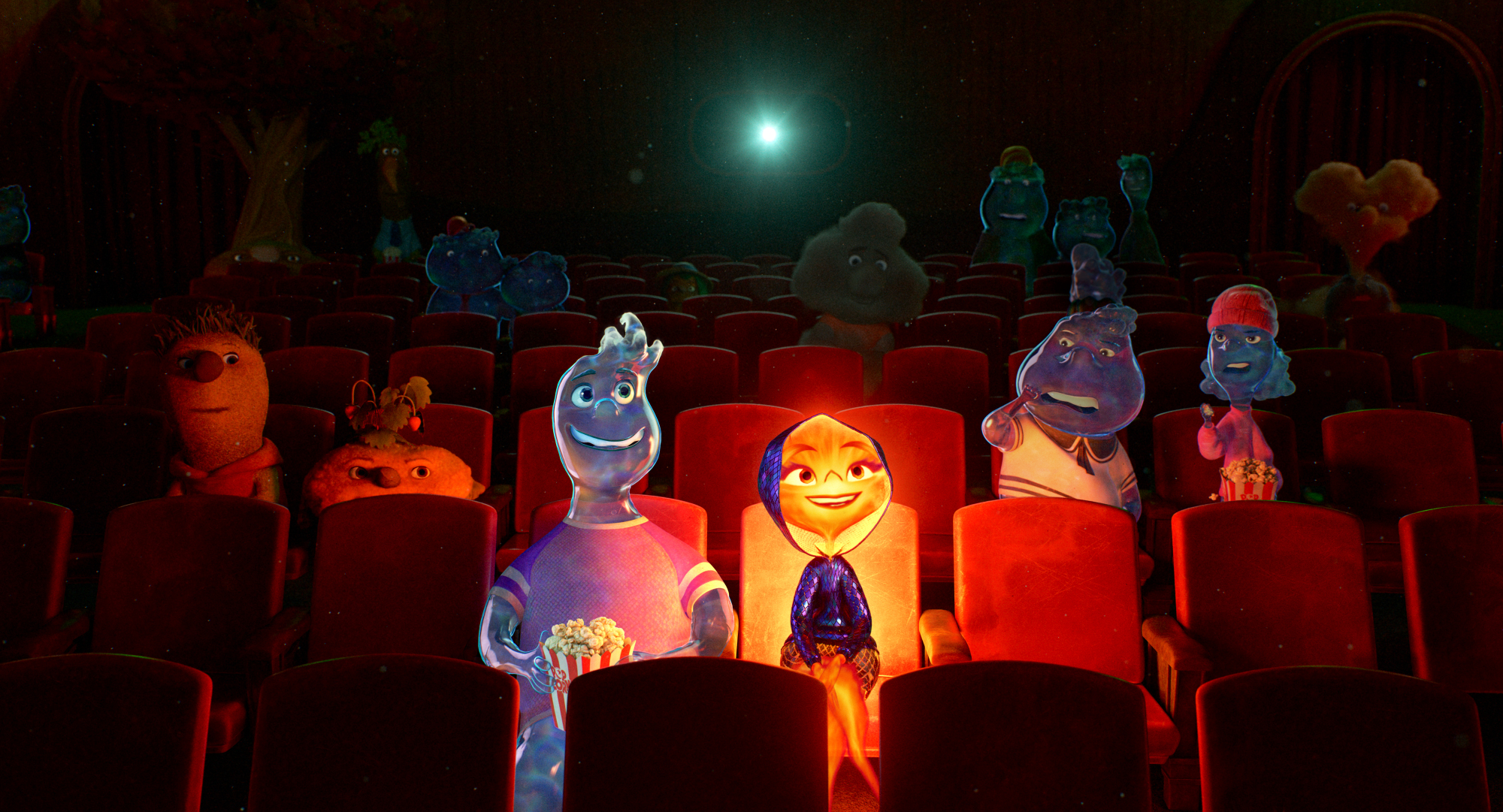 Un homme fait d'eau et une femme faite de feu sont assis dans une salle de cinéma avec des gens de la terre et des gens de l'air.