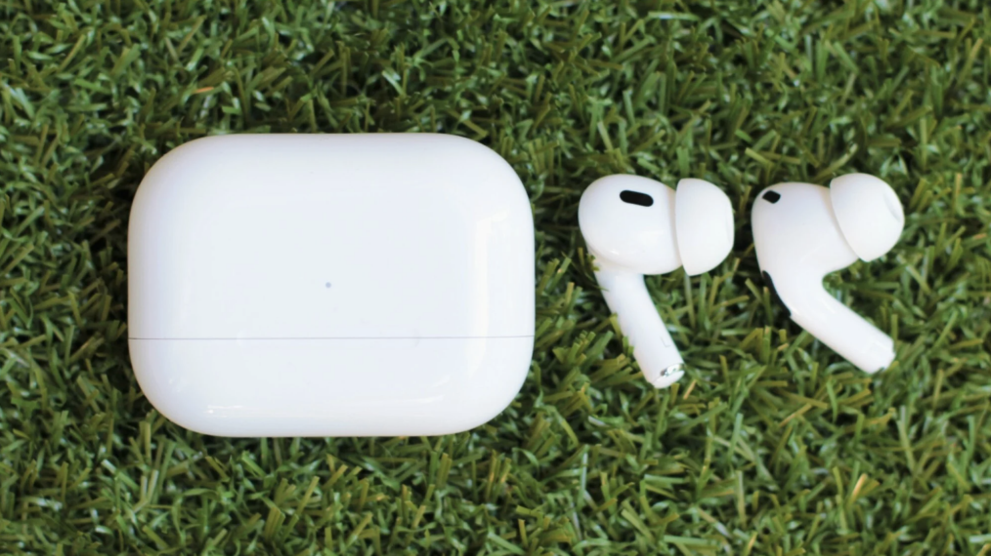 Airpods posés sur l'herbe