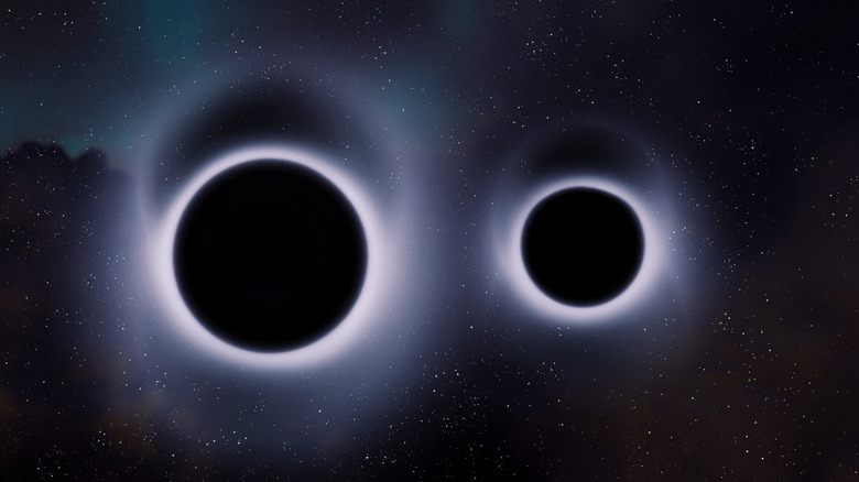 Deux trous noirs sont représentés côte à côte dans l'espace, entourés chacun d'une lumière blanche et brillante.