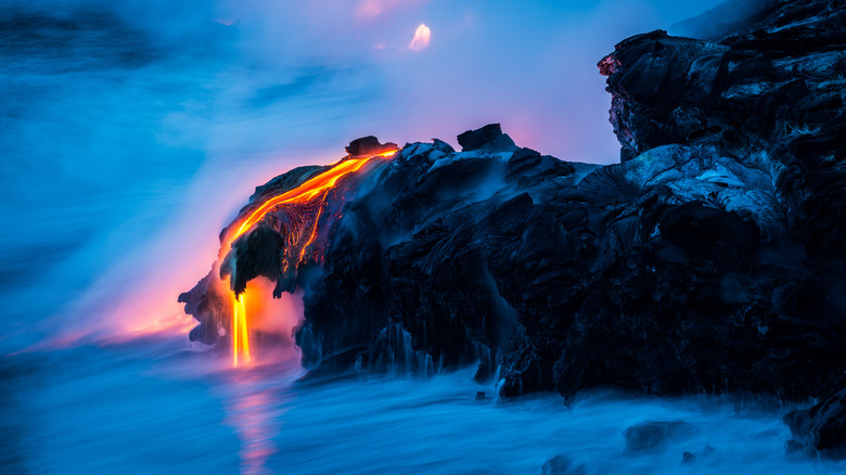 Une photo en accéléré de lave qui coule dans un rock affleure dans l'océan