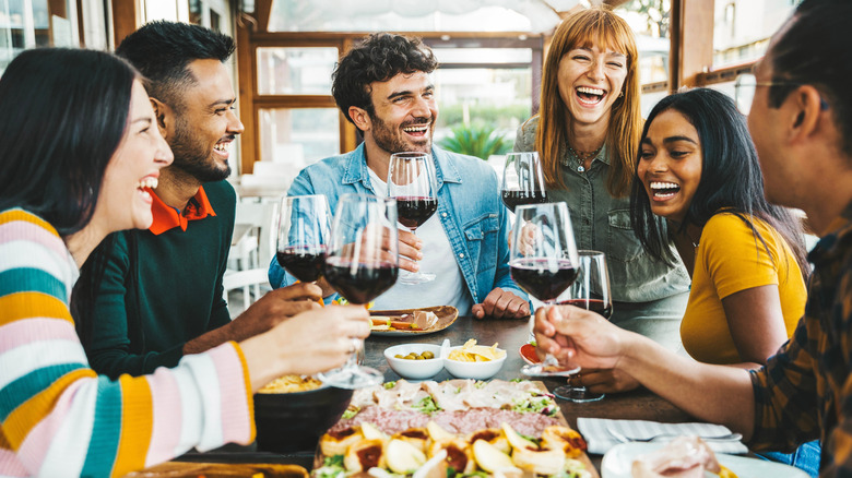 Un groupe d'amis appréciant le vin et les collations