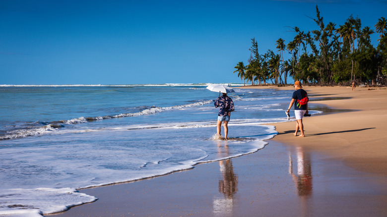 Touristes marchant sur la plage de Luquillo à Porto Rico