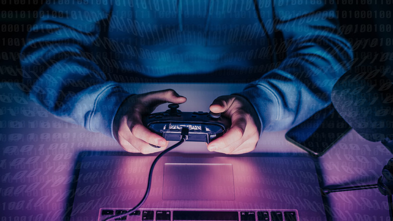 Jeux pour adolescents en ligne sur son ordinateur portable à l'aide d'un contrôleur