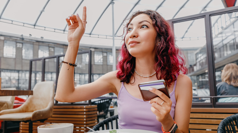 Une jeune femme l'élève a dû attirer l'attention de son serveur dans un restaurant
