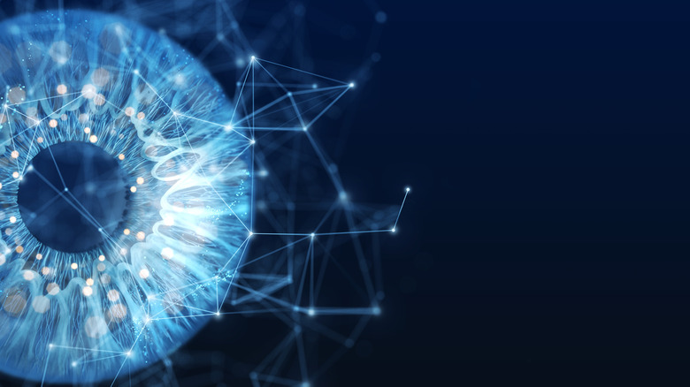 Les particules générées numériquement forment une forme d'iris sur un fond noir.