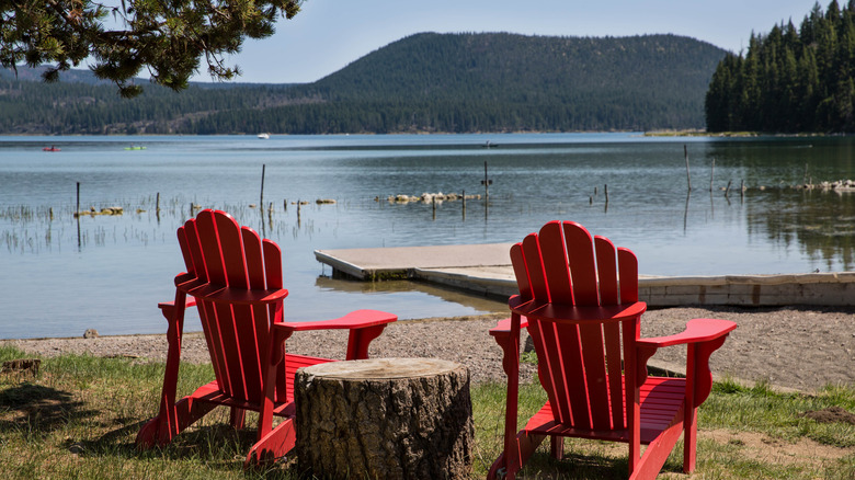 Deux chaises rouges devant un lac