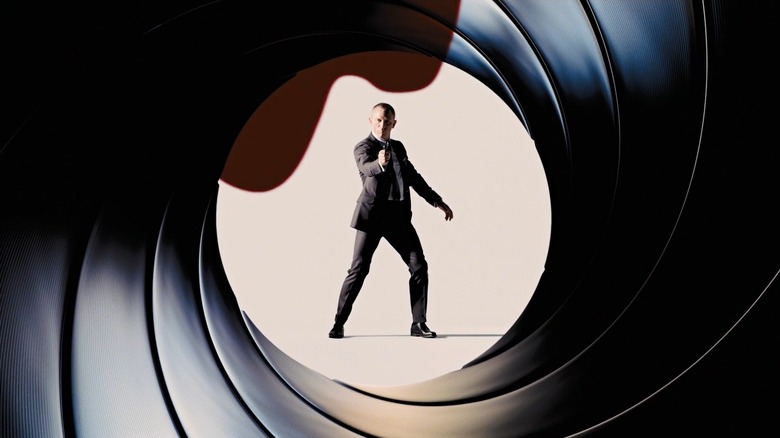Daniel Craig avec un pistolet à la main encadré par un baril de pistolet dans l'intro à un film James Bond
