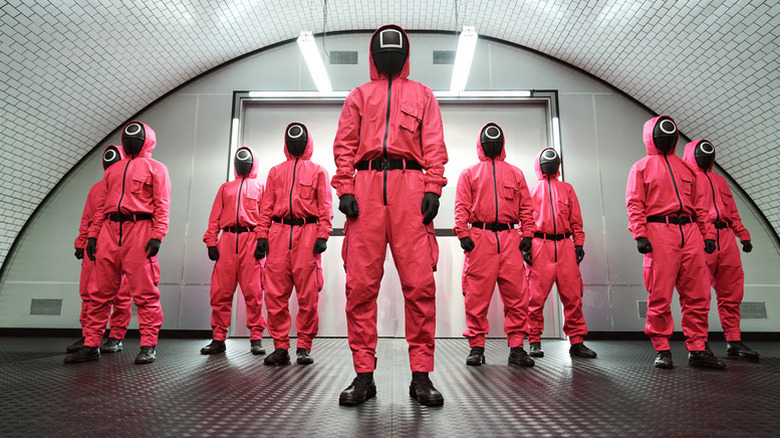 Les employés du jeu de calmar se tiennent côte à côte