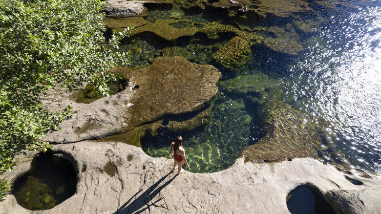 Une femme debout sur les rives d'un trou de baignade