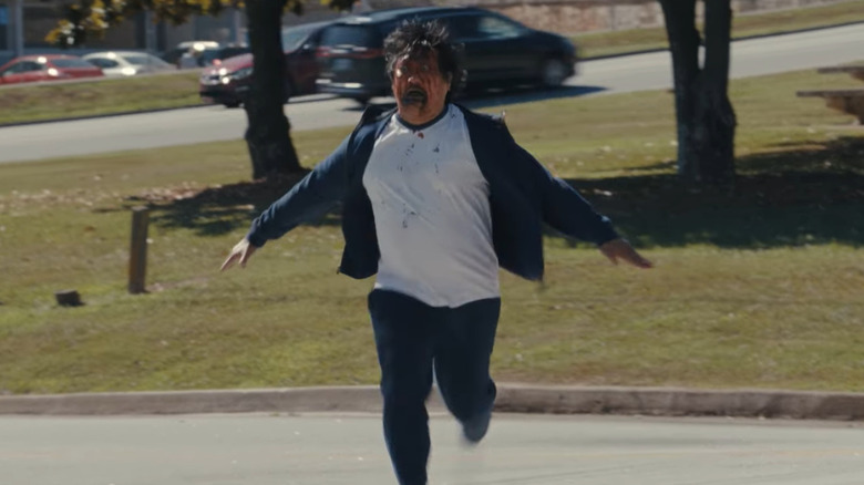 Benedict Wong comme Andrew courant vers Justine avec un visage sanglant dans les armes