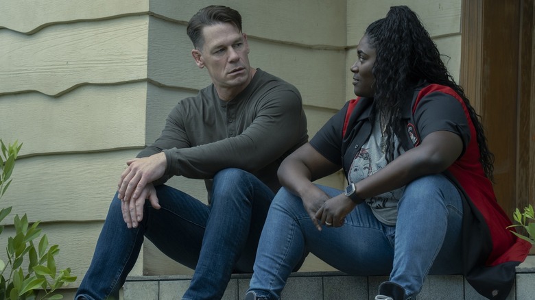 John Cena en tant que Peacemaker et Danielle Brooks comme Adebayo assis sur le porche du pacificateur