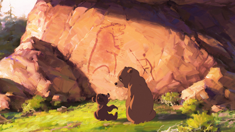 Les ours regardant une peinture sur un rocher dans frère ours