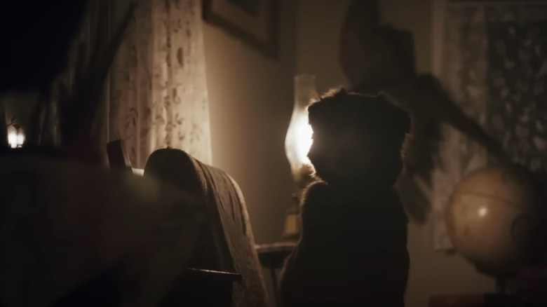 Indy le chien est en train de se détendre contre une lampe dans un salon en bon garçon