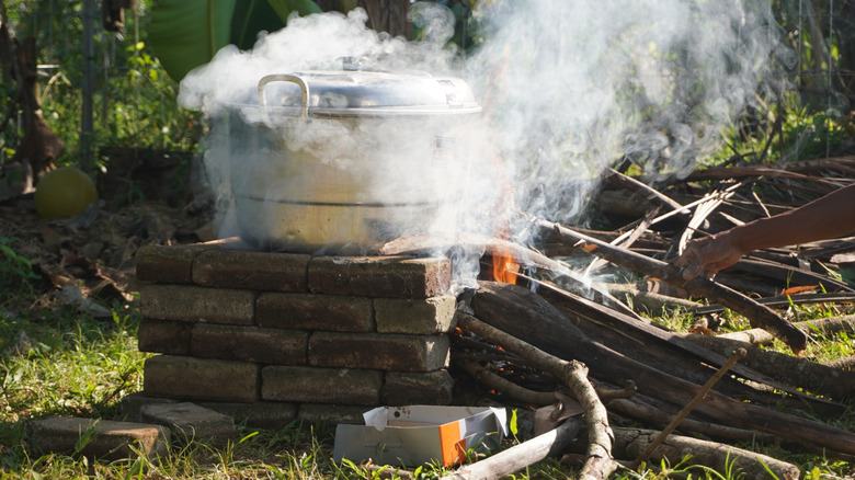 Pot en métal vapeur sur poêle à feu extérieur