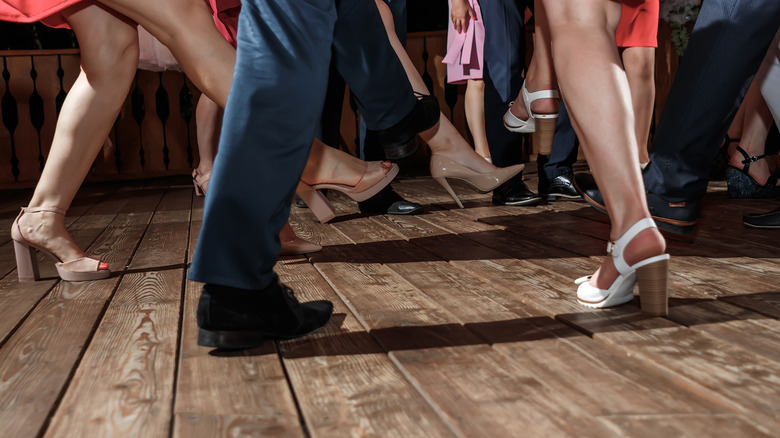 Les pieds de plusieurs personnes dansant du jazz swing sur des planches en bois