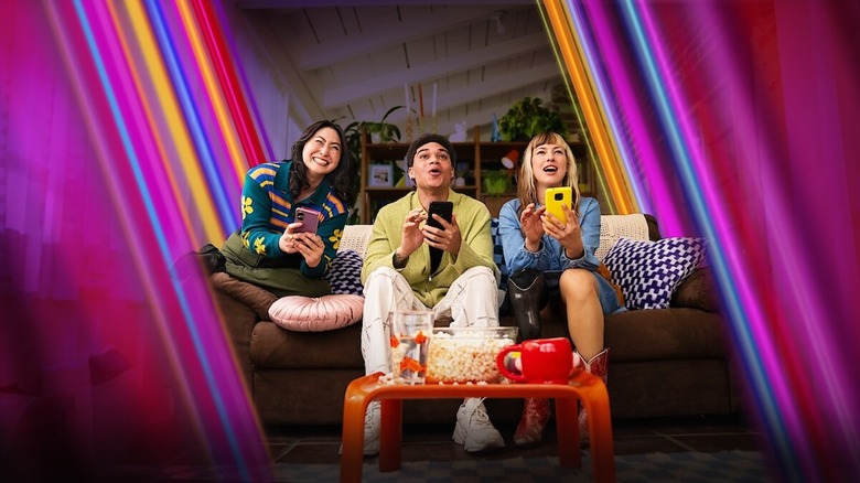 Des gens jouent à Netflix Party Games sur leur canapé avec leur téléphone