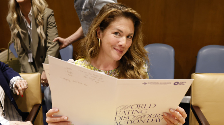 Sophie Grégoire Trudeau souriante en tenant un dossier