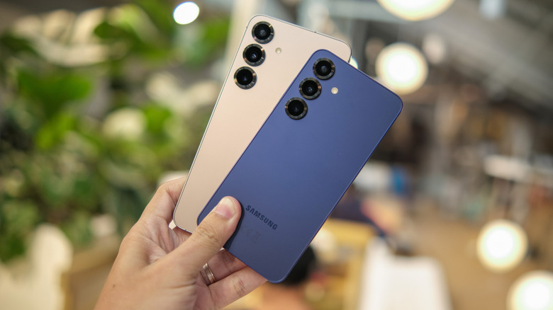 Personne brandissant deux smartphones Samsung Galaxy