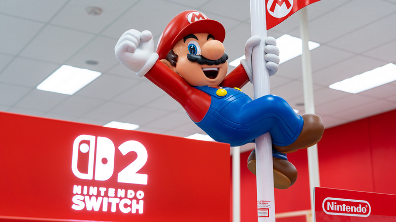 Figurine de Mario tenant un poteau sur un stand Nintendo Switch 2