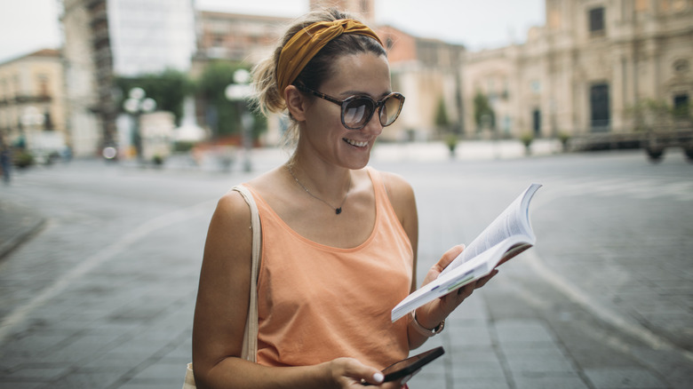 une jeune femme utilisant un guide et une application de navigation
