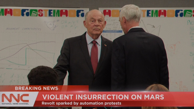 Randy Oglesby dans le rôle du président James Bragg recevant de mauvaises nouvelles d'un assistant alors qu'il se tenait dans une classe d'enfants dans For All Mankind