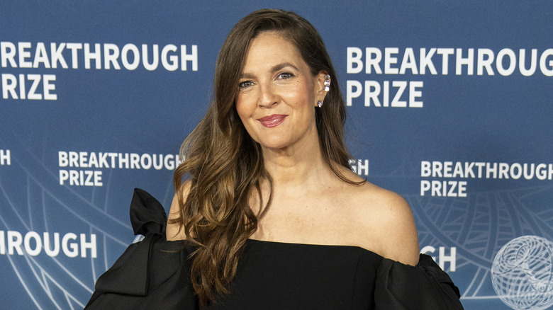 Drew Barrymore fait un doux sourire à la caméra lors d'une séance photo sur le tapis rouge
