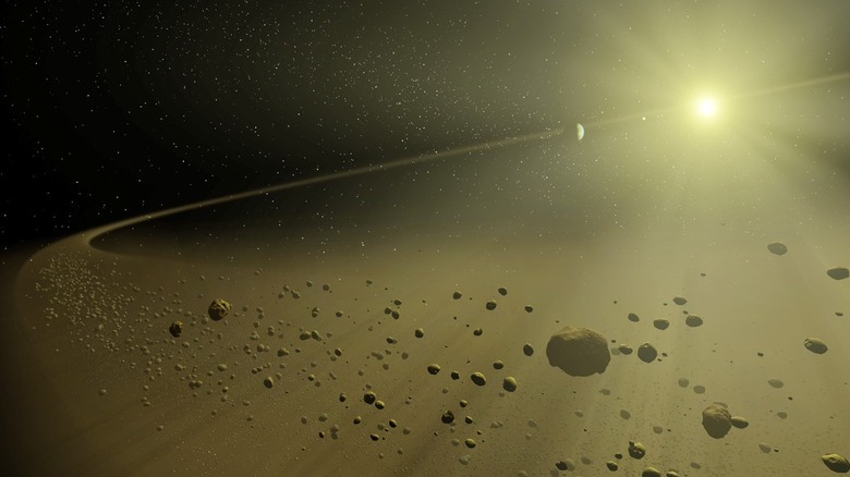 Concept artistique d'un système stellaire se formant avec une étoile brillante entourée de nuages ​​de poussière et de débris rocheux