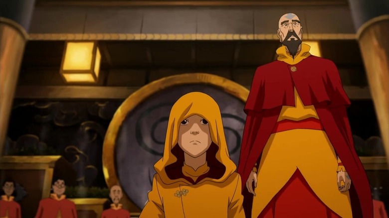 La Légende de Korra - Jinora avec une capuche, agenouillée et Tenzin