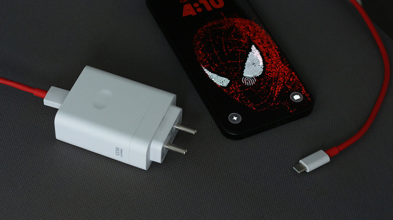 Un téléphone OnePlus à côté de son chargeur