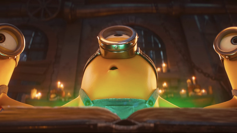Les Minions se rassemblent autour d'un livre vert brillant dans Minions & Monsters