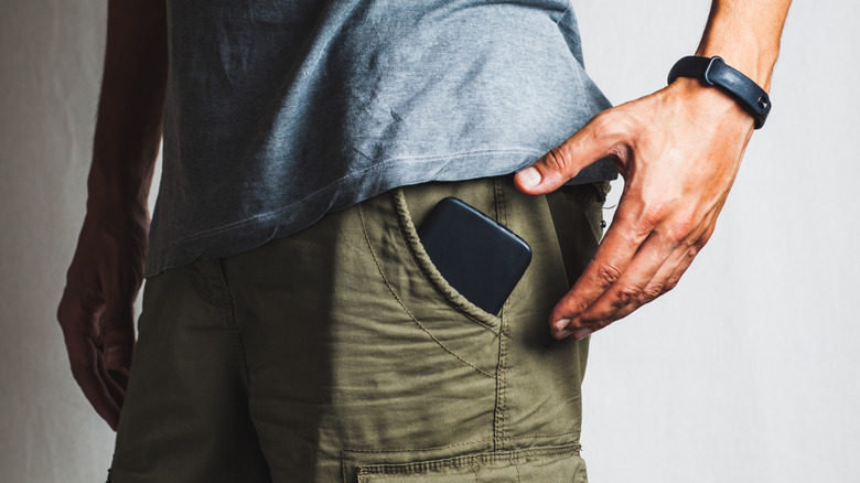 Personne avec un téléphone dans sa poche.