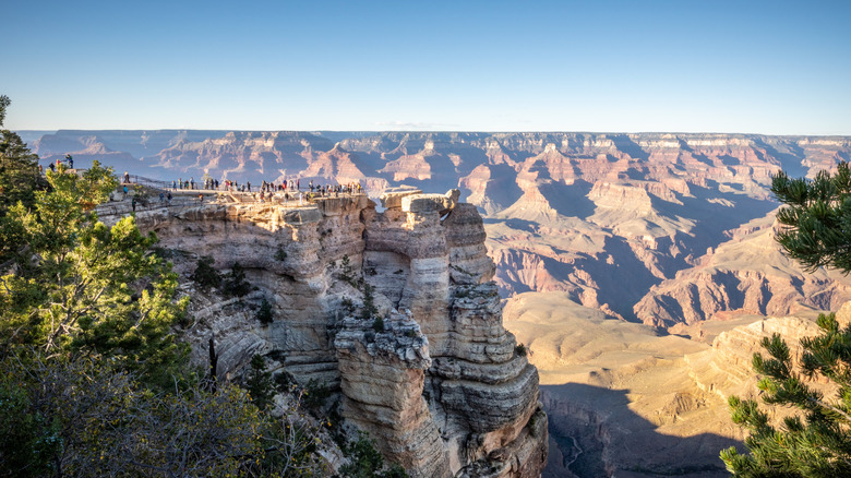 les touristes se tiennent à Mather Point, un belvédère sur le bord sud du Grand Canyon