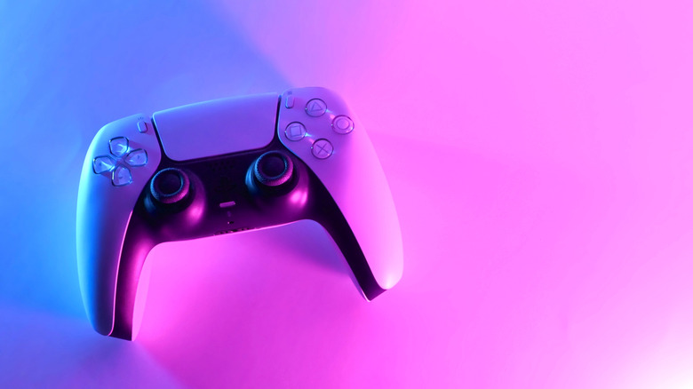 Une manette PS5 sur fond dégradé rose et bleu
